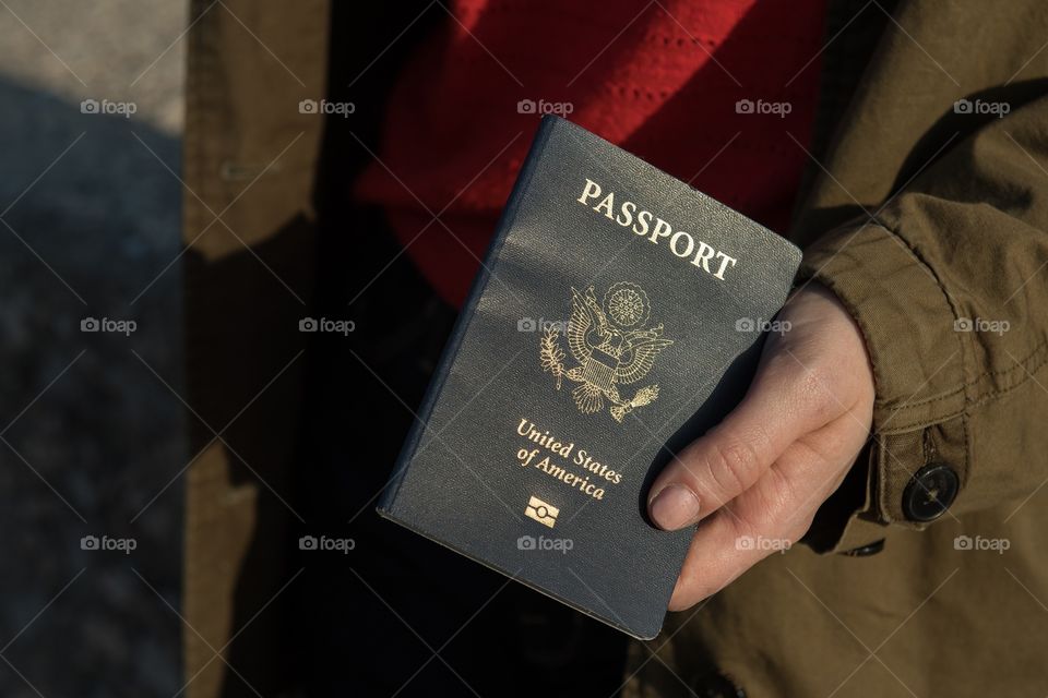 Hand holding US passport