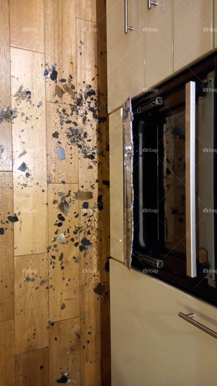 Oven front door explosion. Shattered glass on kitchen floor.