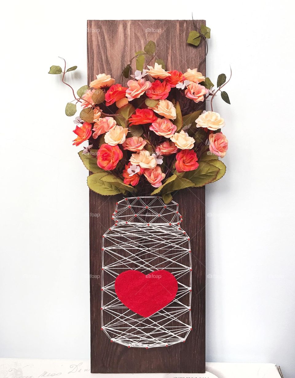 Handmade wooden wall art decor. Vase with flowers