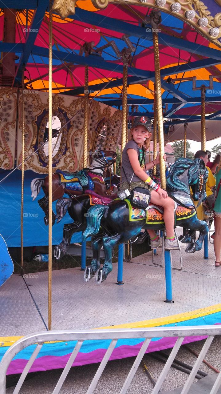 kid on carousel