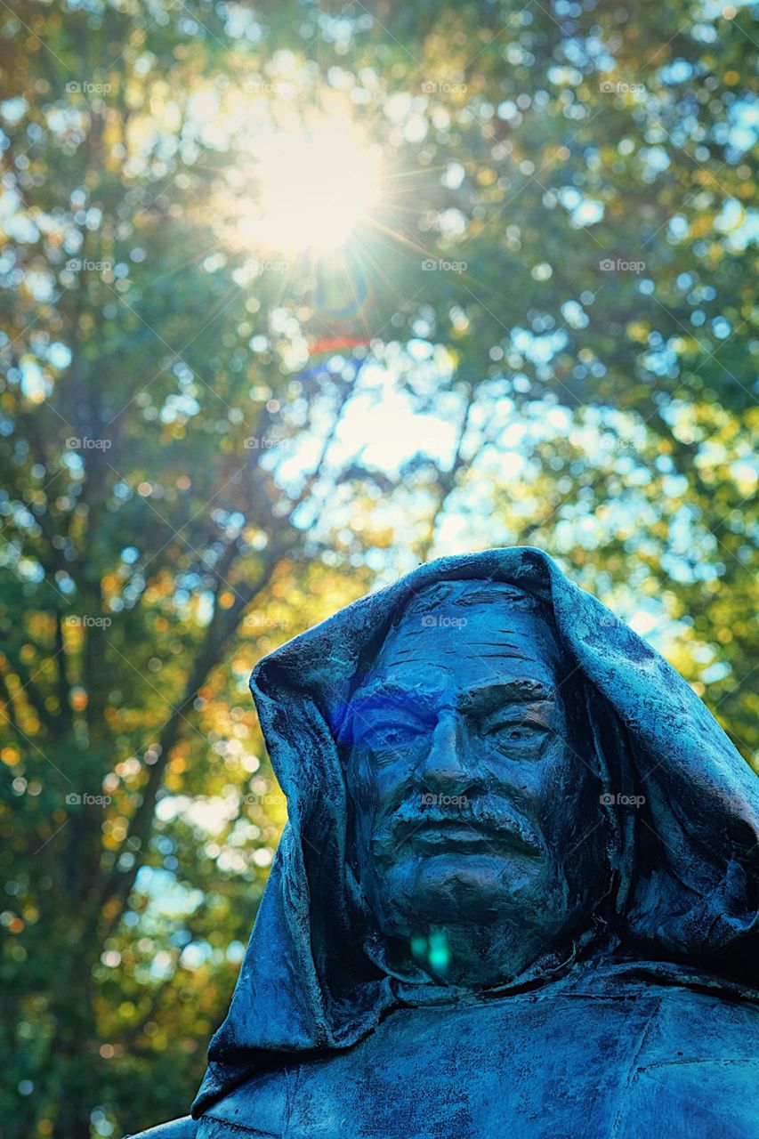 Statue Of A Man In A Park, Westbury Gardens In New York, Sunshine Through The Statue, Backlit Statue In The Fall Time 