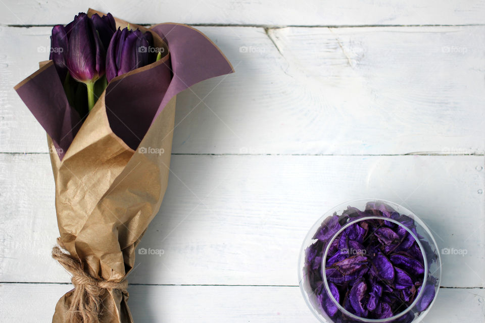 A bouquet of tulips and purple rose petals: congratulations, March 8 (International Women's Day), February 14th (Valentine's Day), holiday