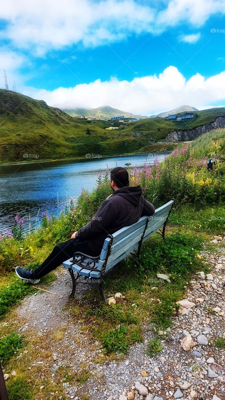 young man on bench chill in amaizing nature