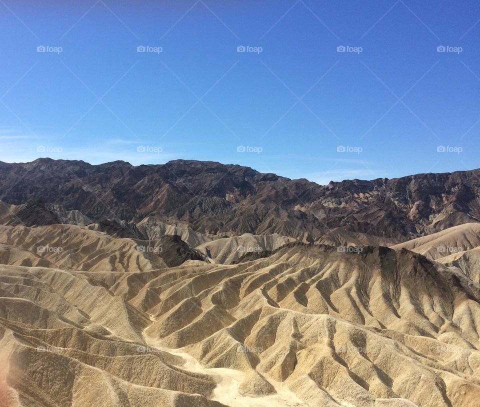 Dry mountain chain view with natural formation and a blue sky