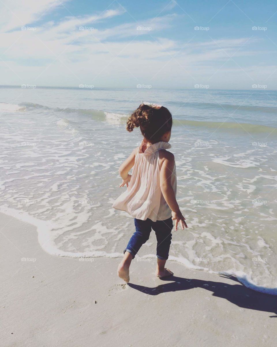 little girl enjoying the beach