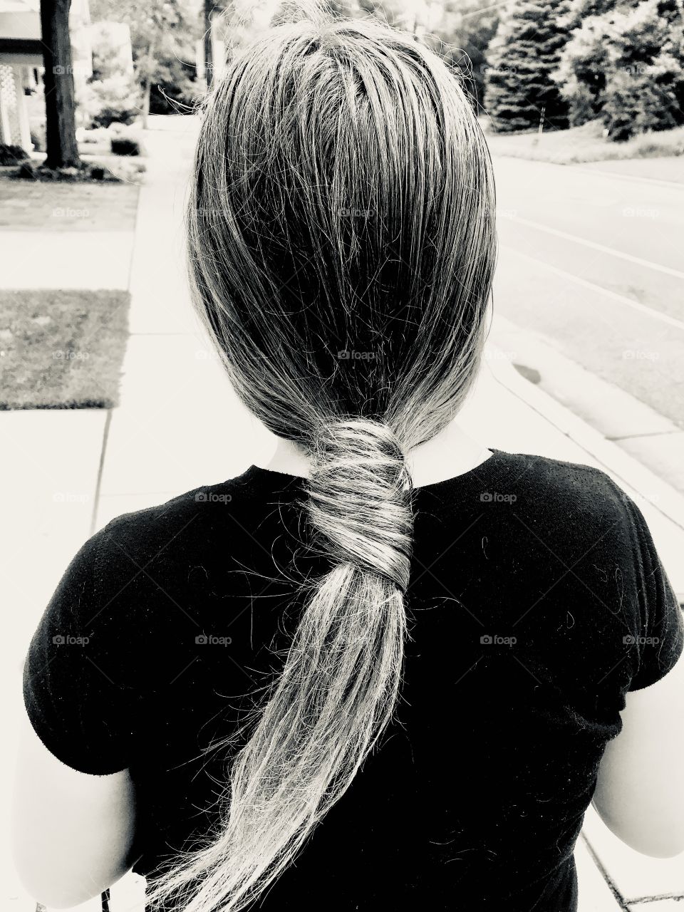 Fun black and white photo of pony tail tied with its on hair makes for an interesting picture. 