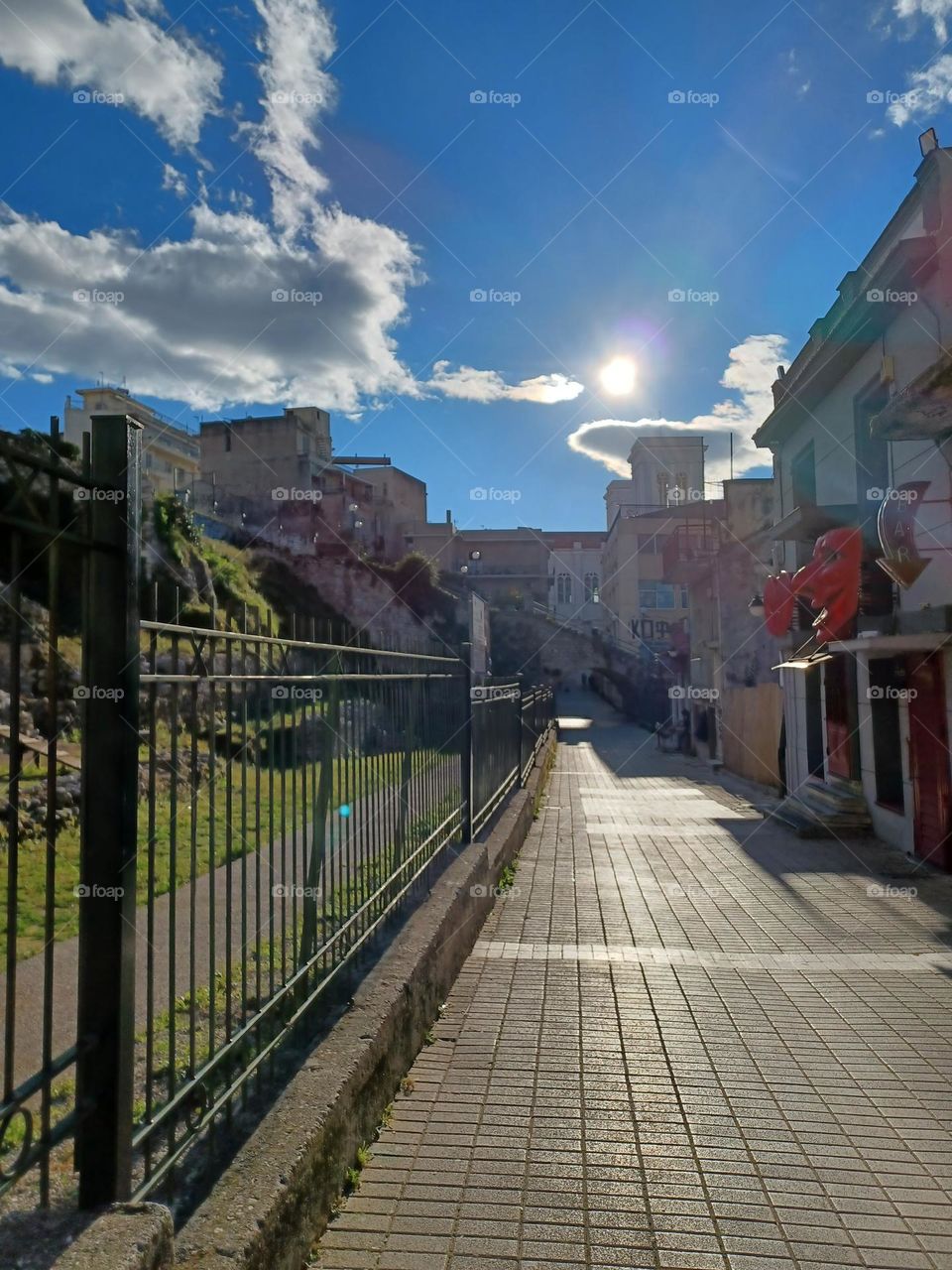 Hfaistou street, Patras, Greece.

☆Colored cafes and taverns, next to archeological finds, in the city. In the evenings the sidewalk is filled with joung and old people, who have fun until the morningl