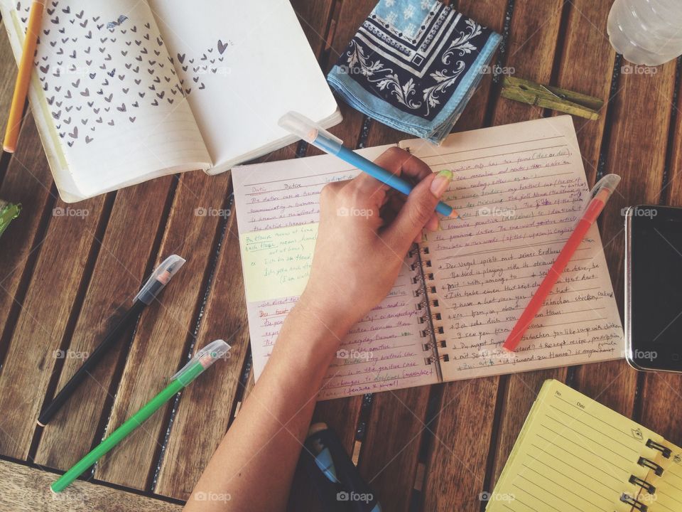 Woman hand writing on notebook with pen