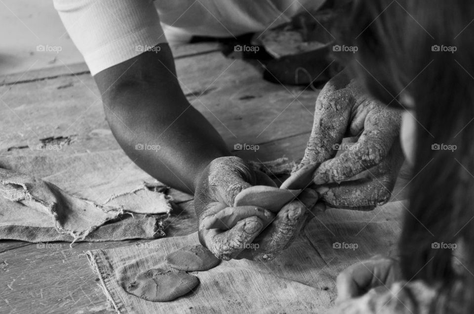 Craftsman teaching girl to model