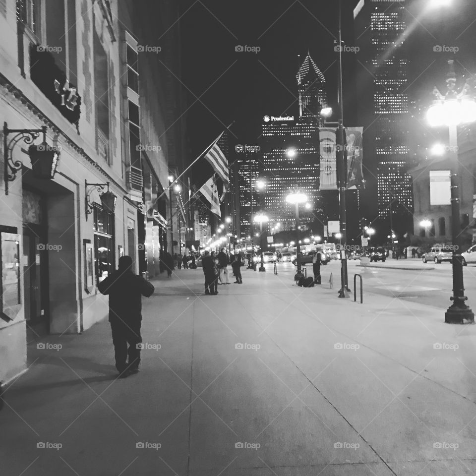 Walking down downtown Chicago street at night.