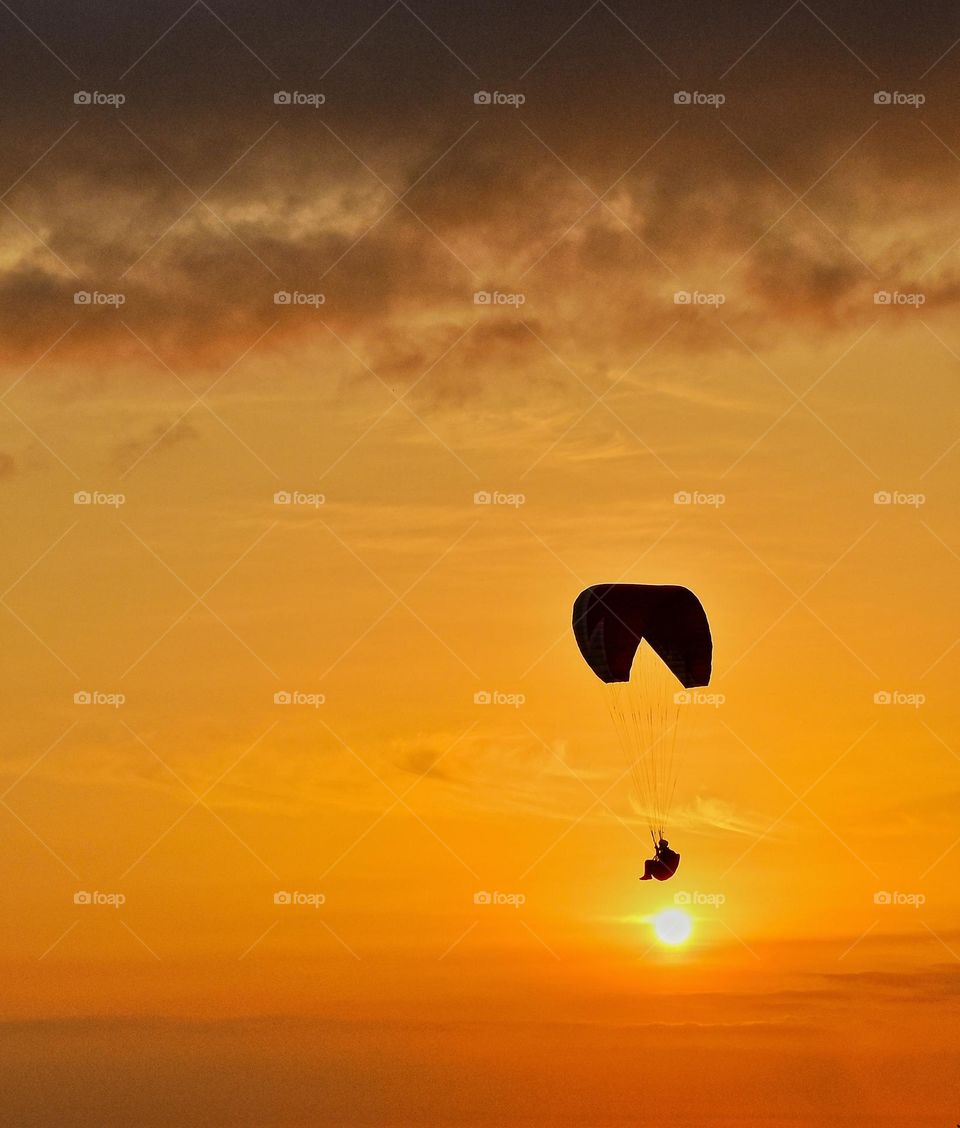 Sunset and paragliding