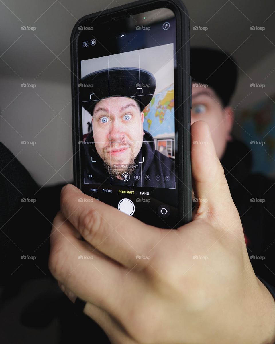 Selfie being taken on an iPhone 13 in portrait mode