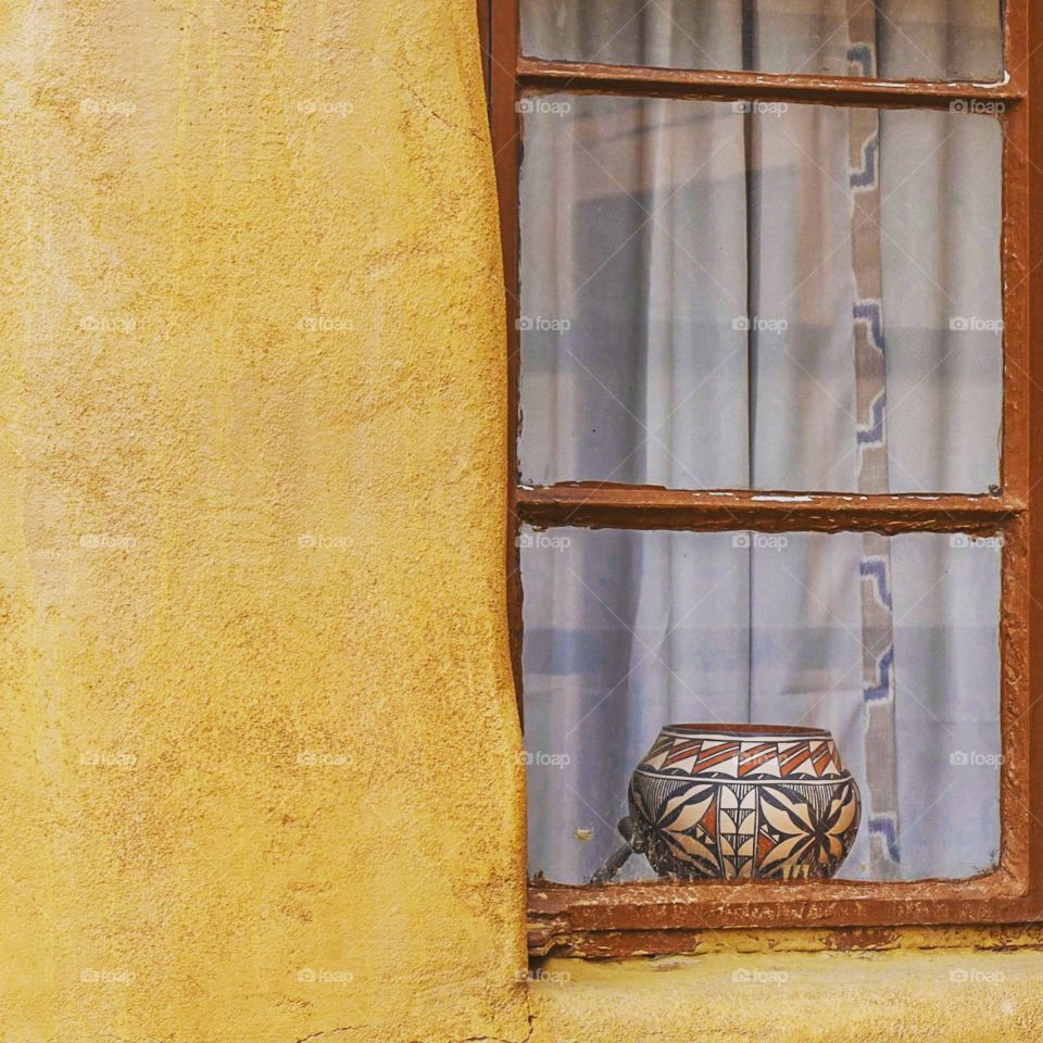 Old Acoma pottery in a window