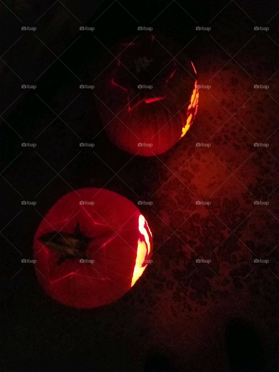 two glowing jack-o-lanterns from above.