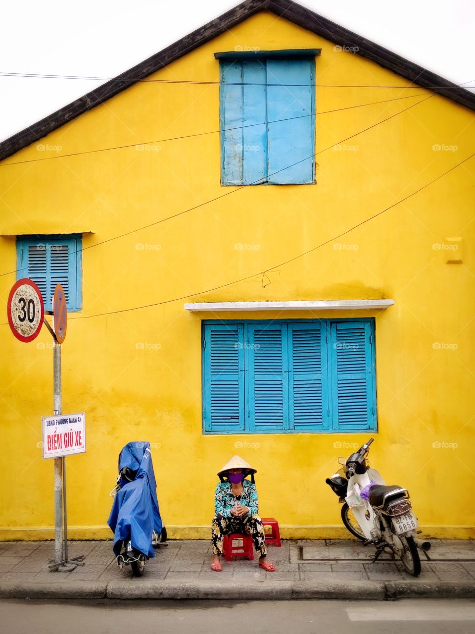 Yellow house with blue window shutters