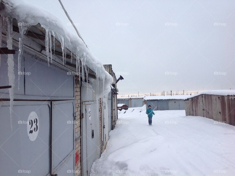 child with icicle in hands
