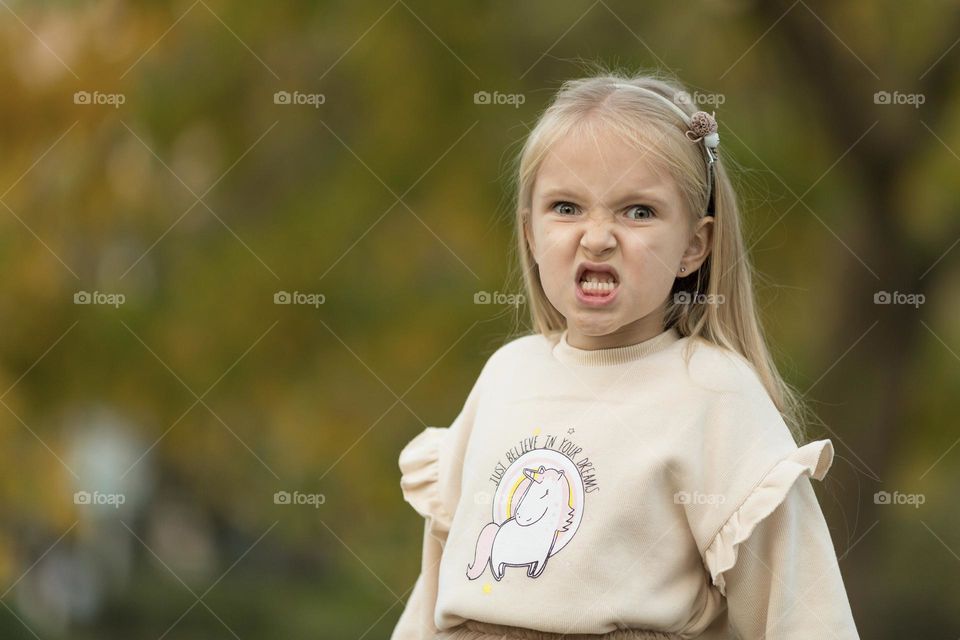 Portrait of little Caucasian girl feeling anger 