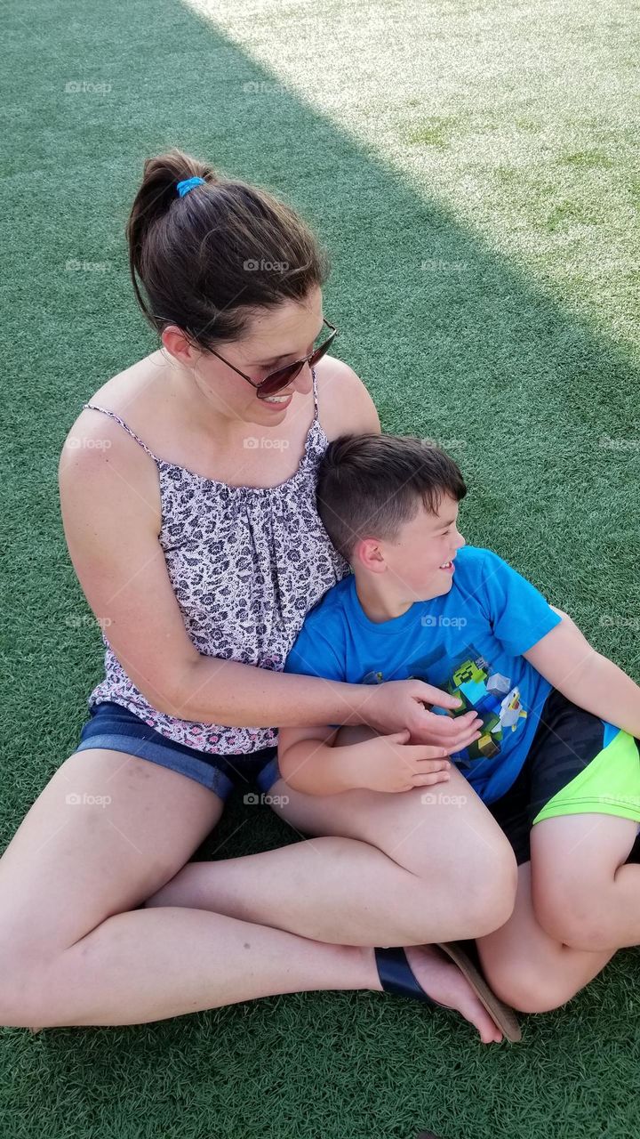 mom and son having a silly moment while waiting outdoors in the Midwest during Summer