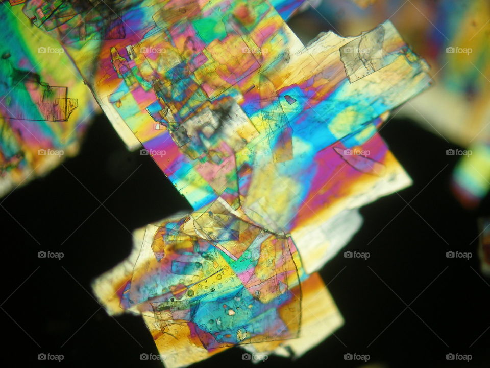 Liquid crystal under polarized light showing rainbow colors.