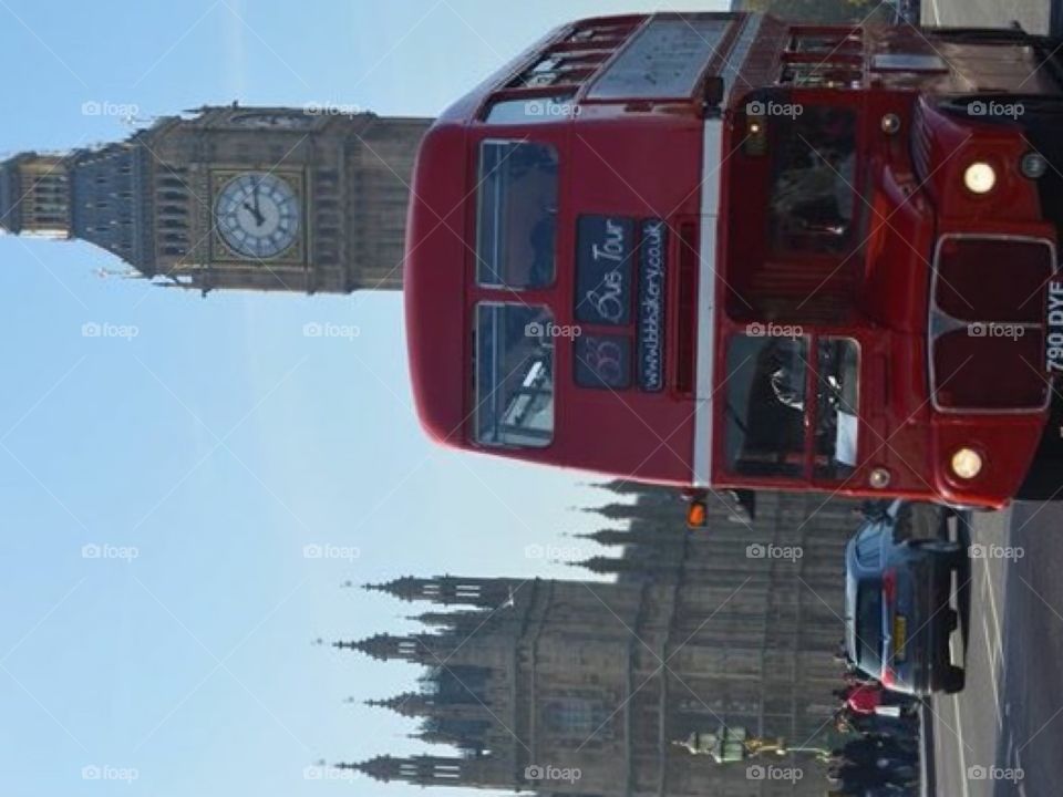 The iconic London red bus in front of the Houses of Parliament 