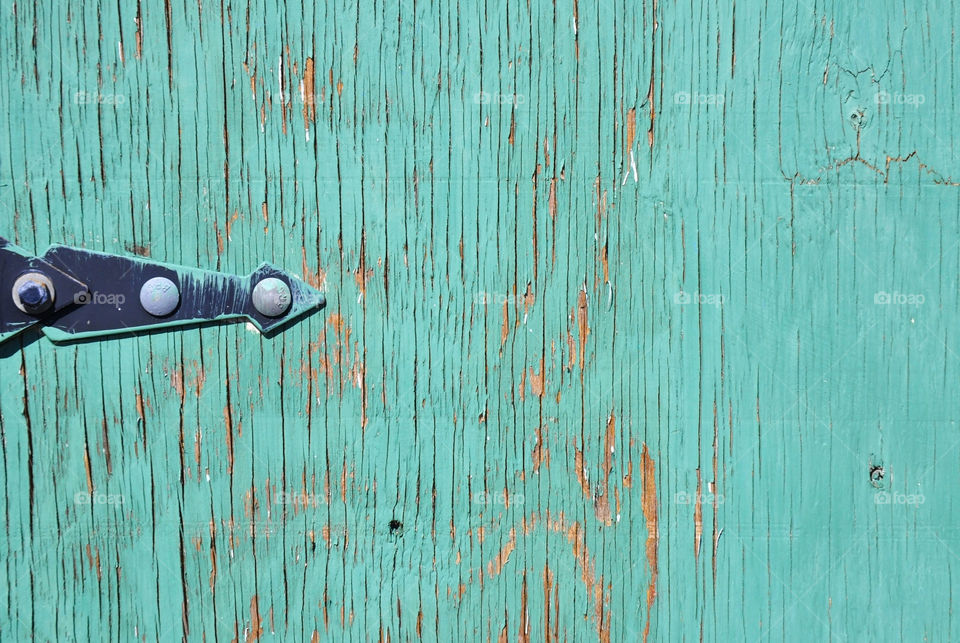 Weathered turquoise door perfect for a background pattern or for copy overlay.