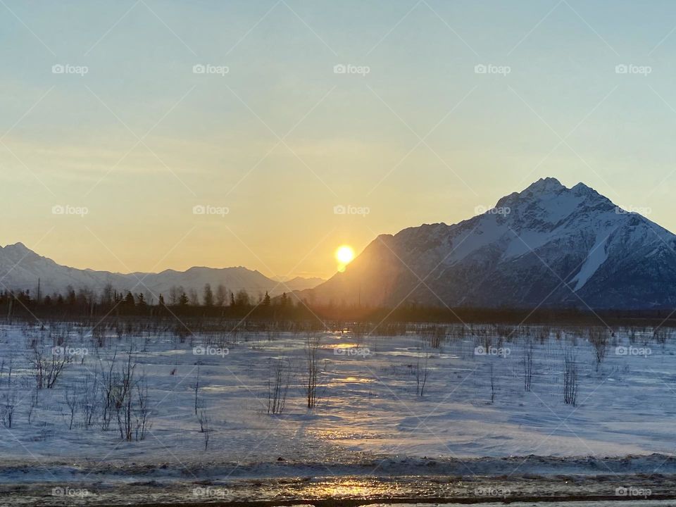 Sunrise over the snowy mountains near Anchorage Alaska Route 1