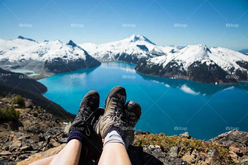 Two people's legs and view of landscape
