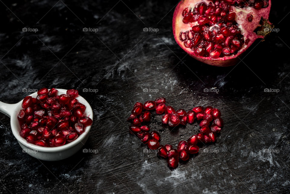 seductive pomegranate red seeds in a shape of heart