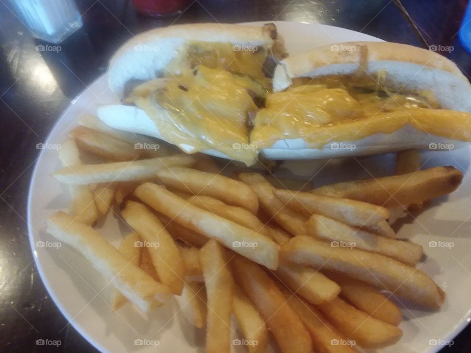 philly cheese steak sandwich with golden fries