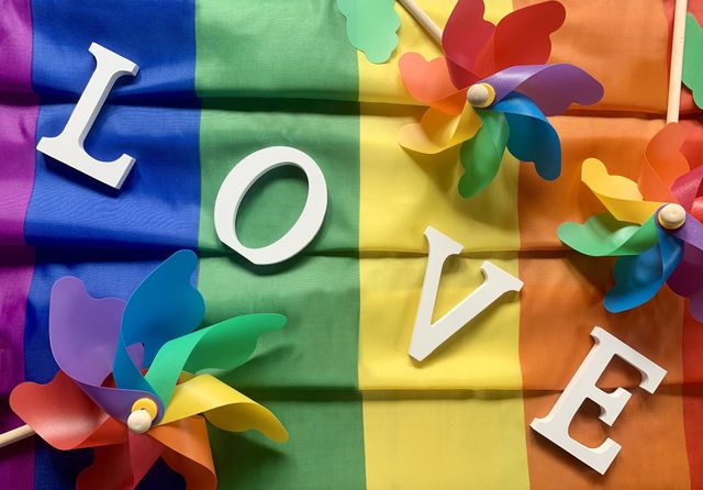 The word Love spelled out on a rainbow coloured background 