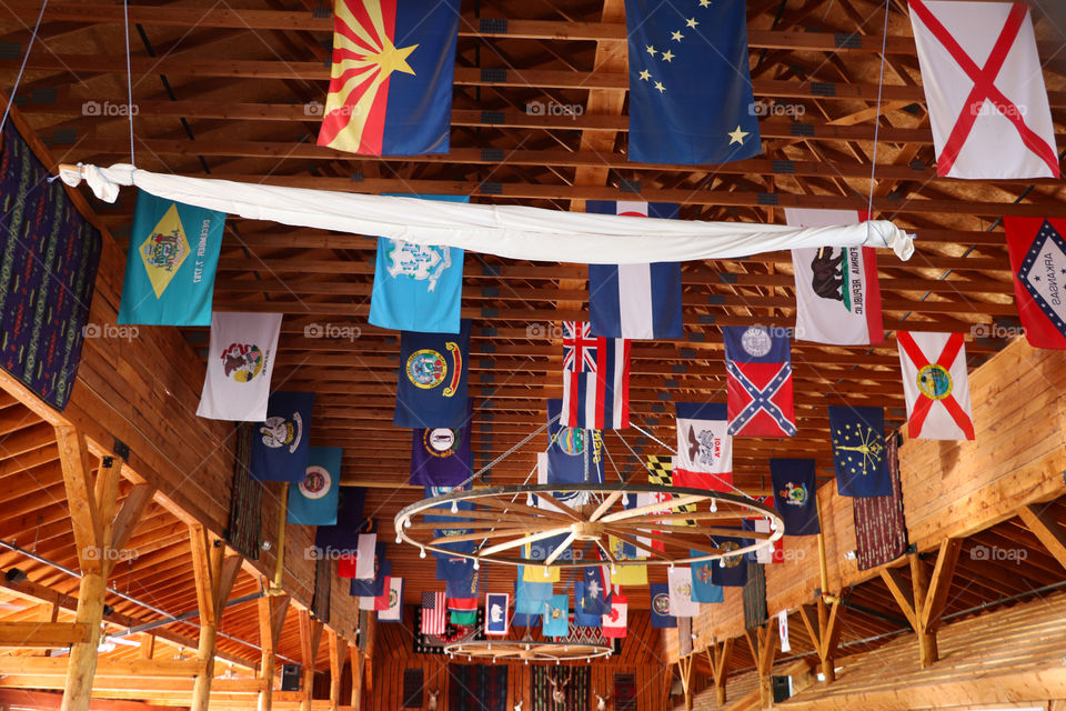 Flags hanging on the ceiling on a wooden structure