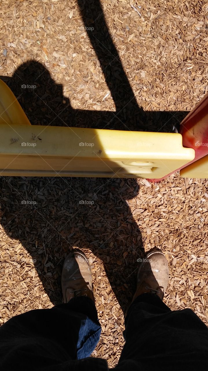 standing on wood chips at the playground at work