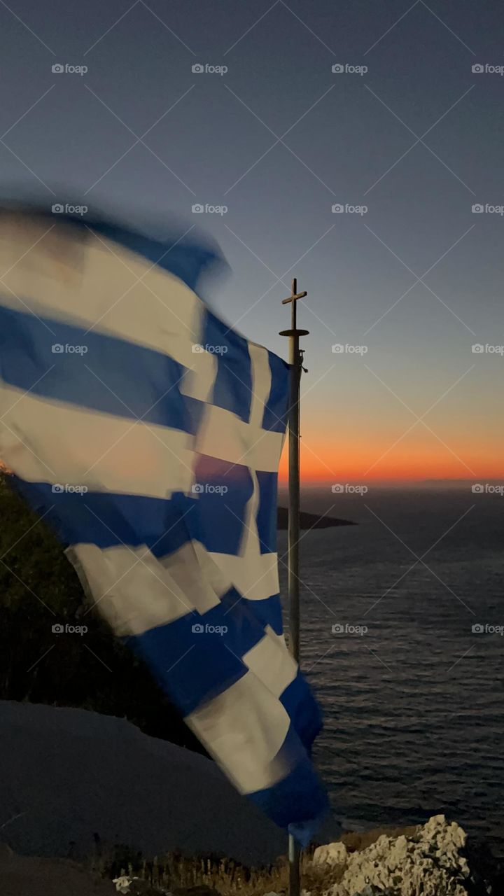 The Greek flag with the Aegean in the background