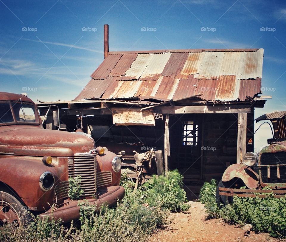 Abandoned vintage vehicles and shack at Ghost town in Arizona 
