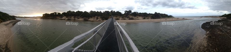 Bridge across water beach ocean inlet