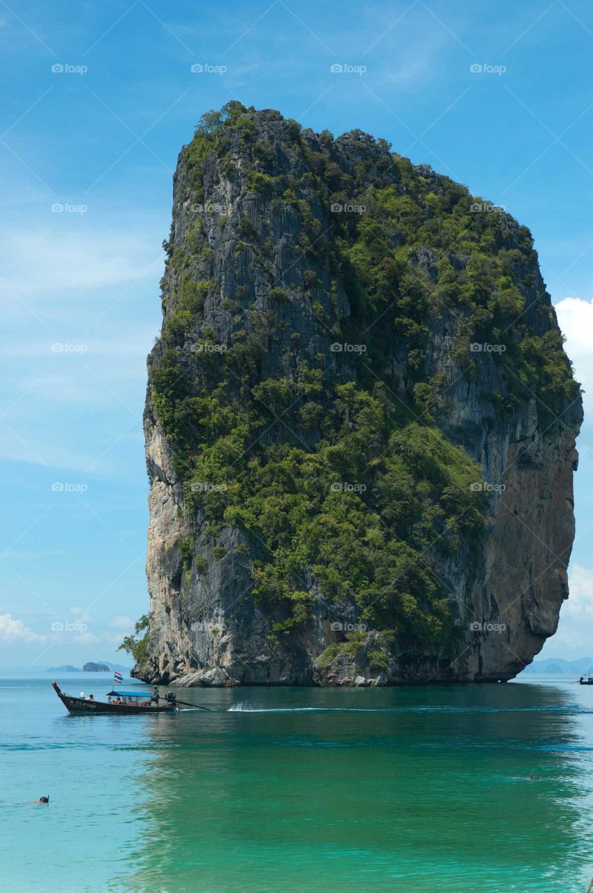 A rock in the water off the coast of Thailand.
