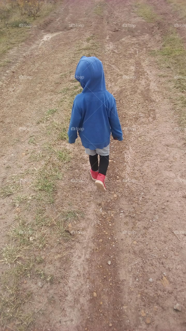 a kid walking alone.