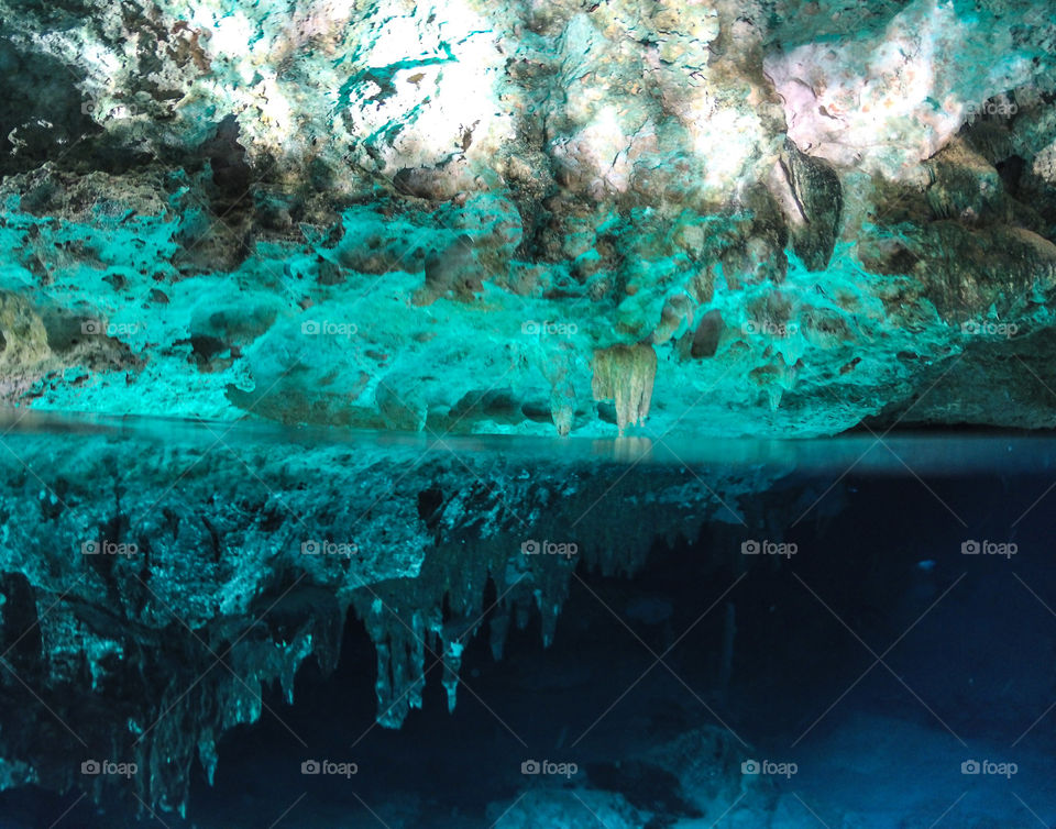 split shot of cave in Dos Ojos cenote