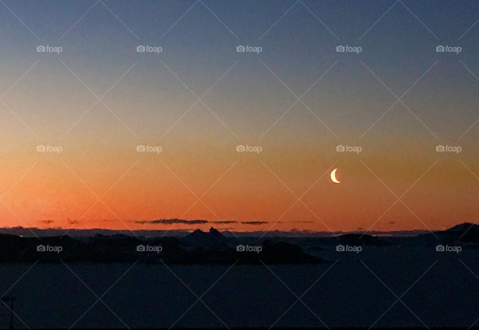 Sunset captured on 29/05/2017 at 3:00 pm at Bharati research station,Antarctica. The beauty of sunset over the left side and moon setting in from right side is just phenomenal. 