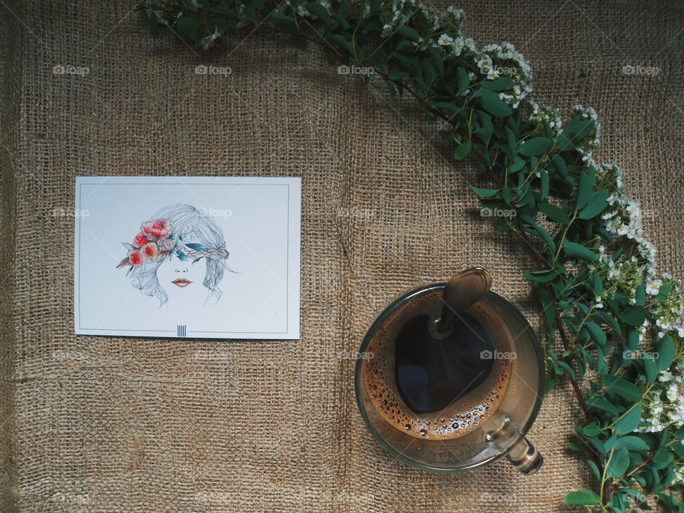 Coffee, flowers and a postcard. Write home a letter