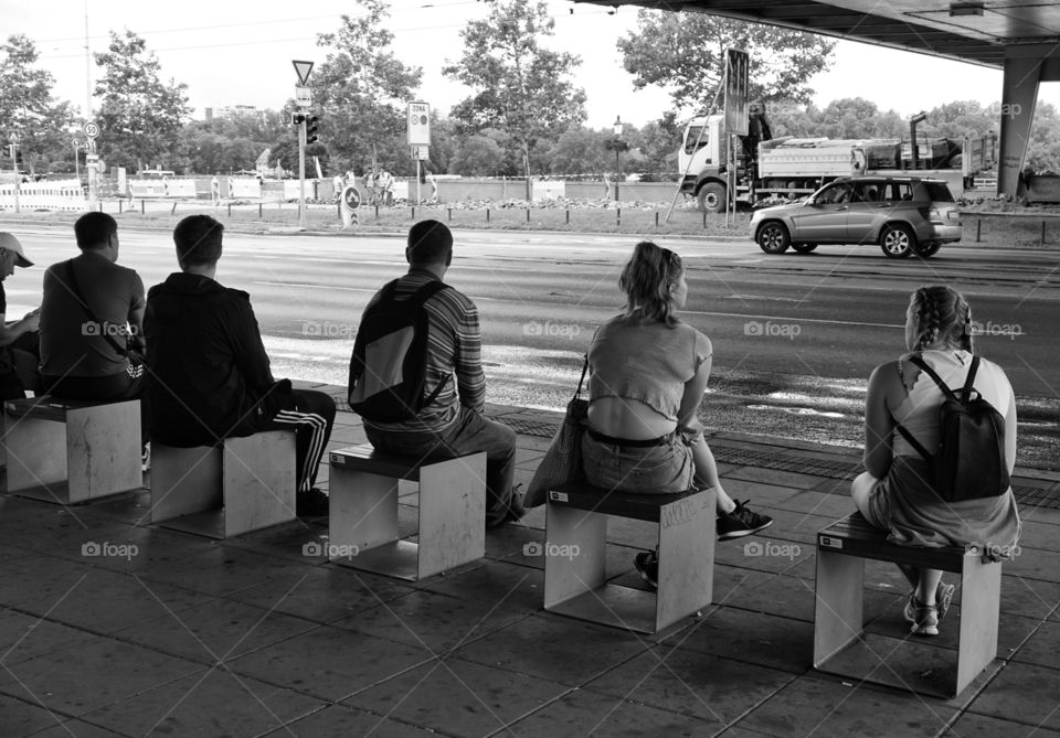 Rectangle Mission sitting on cubes at a bus stop 