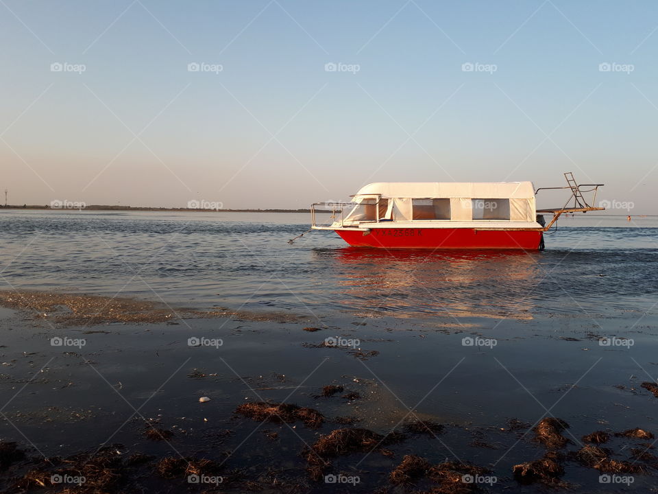 Red and white boat at the lake