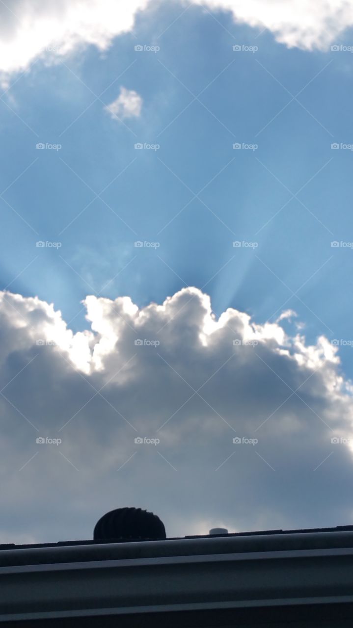 sunbeams. clouds passing over the sun