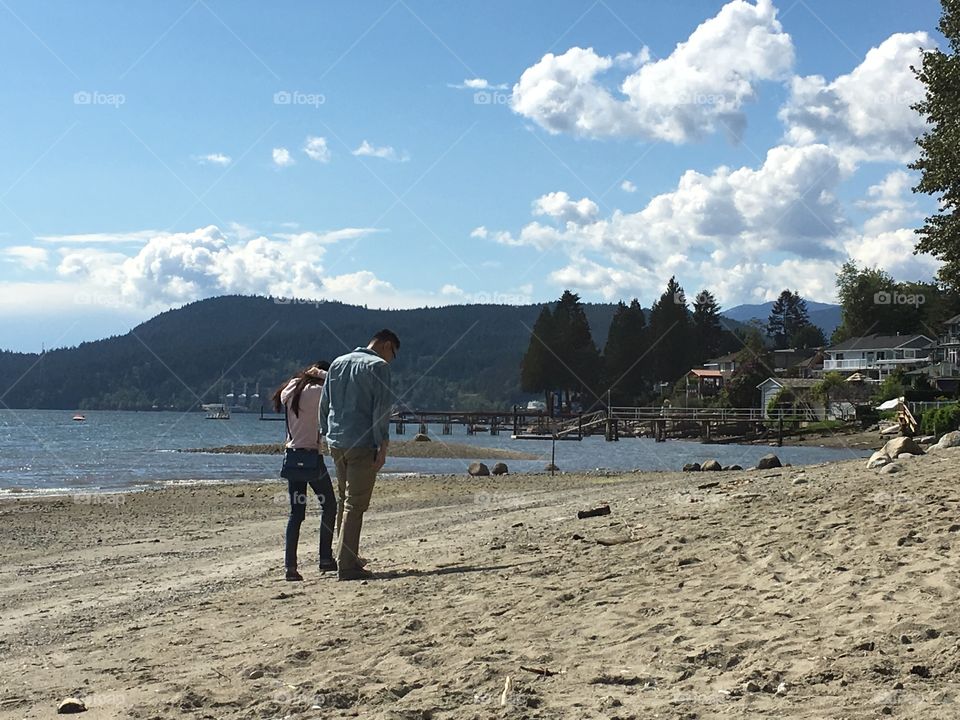 Asian couple walking in the beach