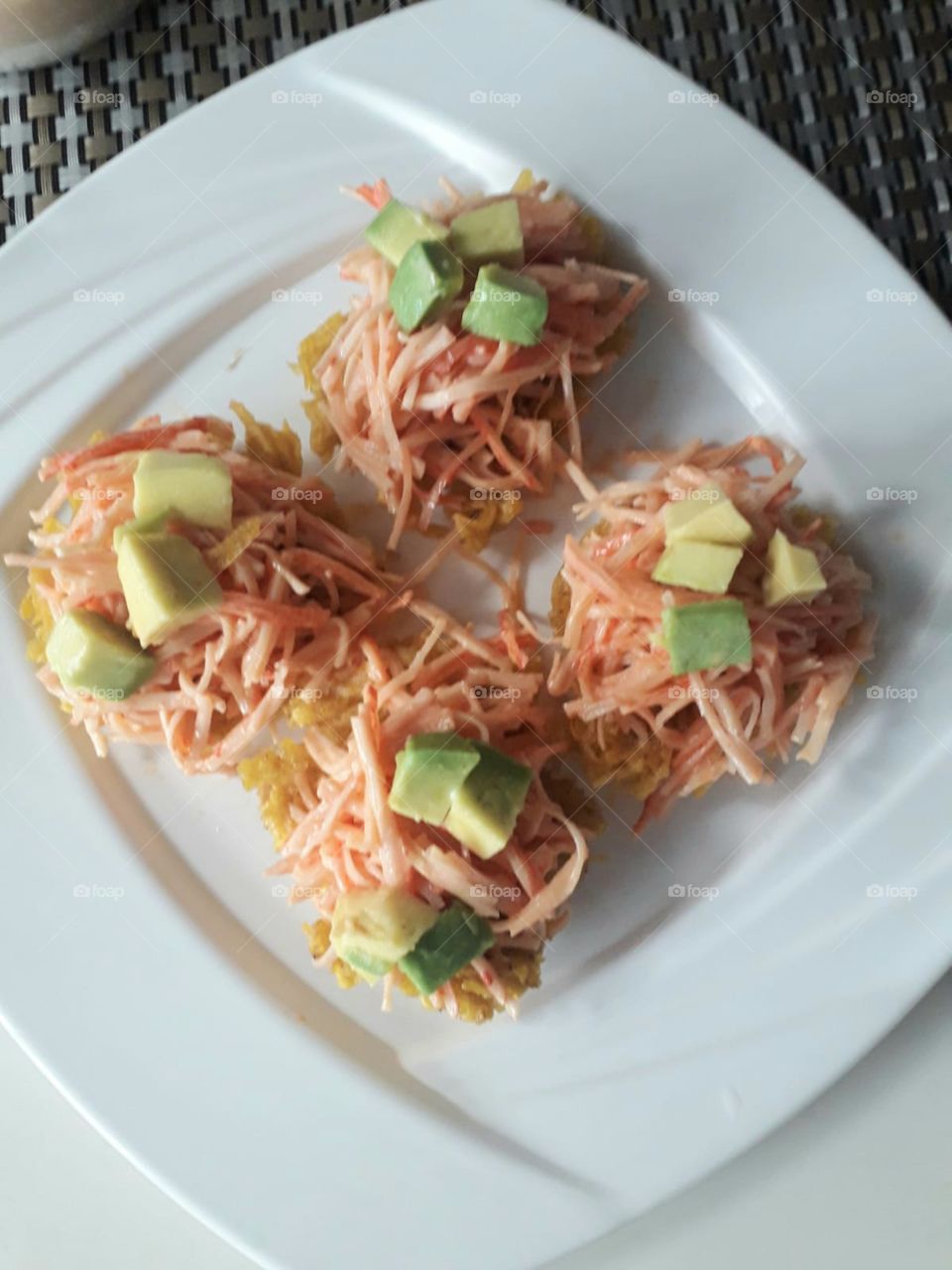 Spicy Crab over Arañitas with avocado