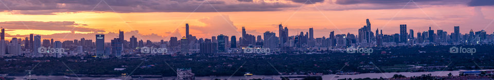 Panorama view of twilight moment with cloudy and fog over skyscraper in Bangkok