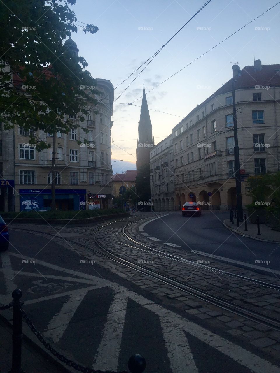 Rail tracks on a turning street in the evening 