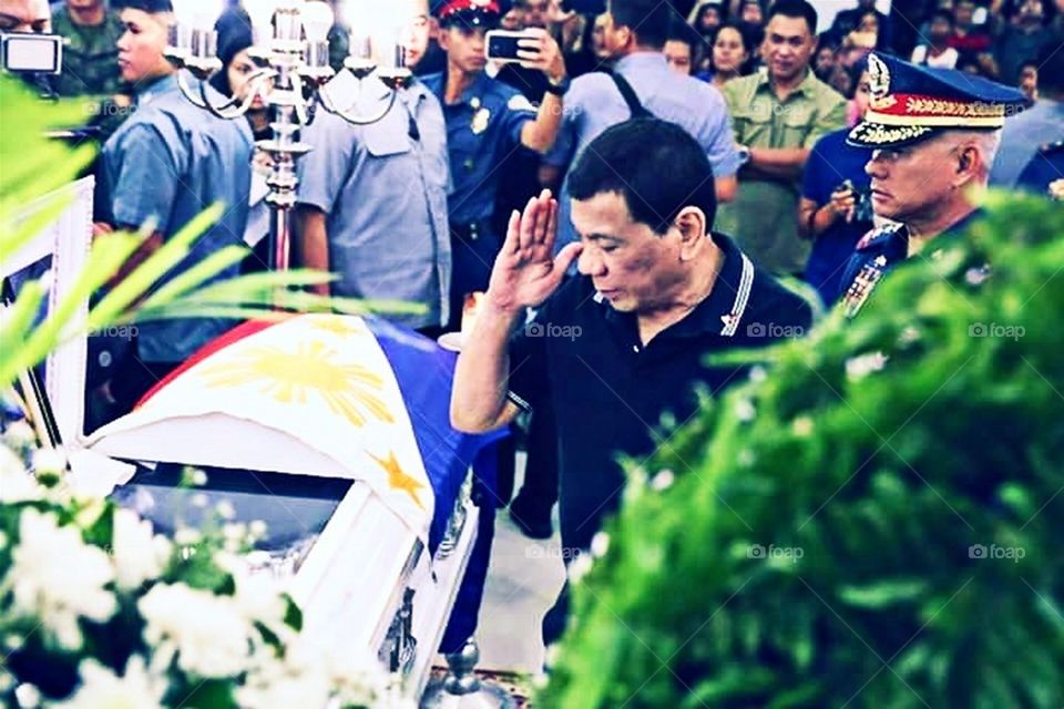 Philippine President Saluting A Fallen Policeman