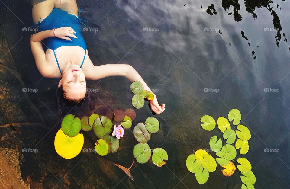 woman in the pond with water lilies