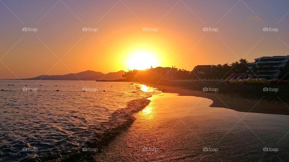 Scenic view of beach at sunset